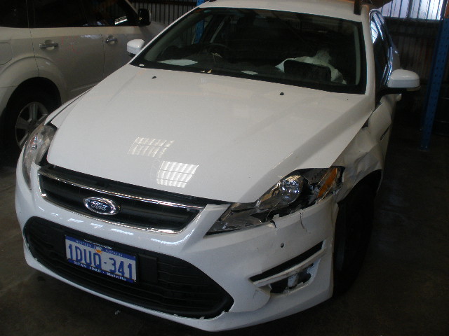 Ford sedan with front collision damage before repair
